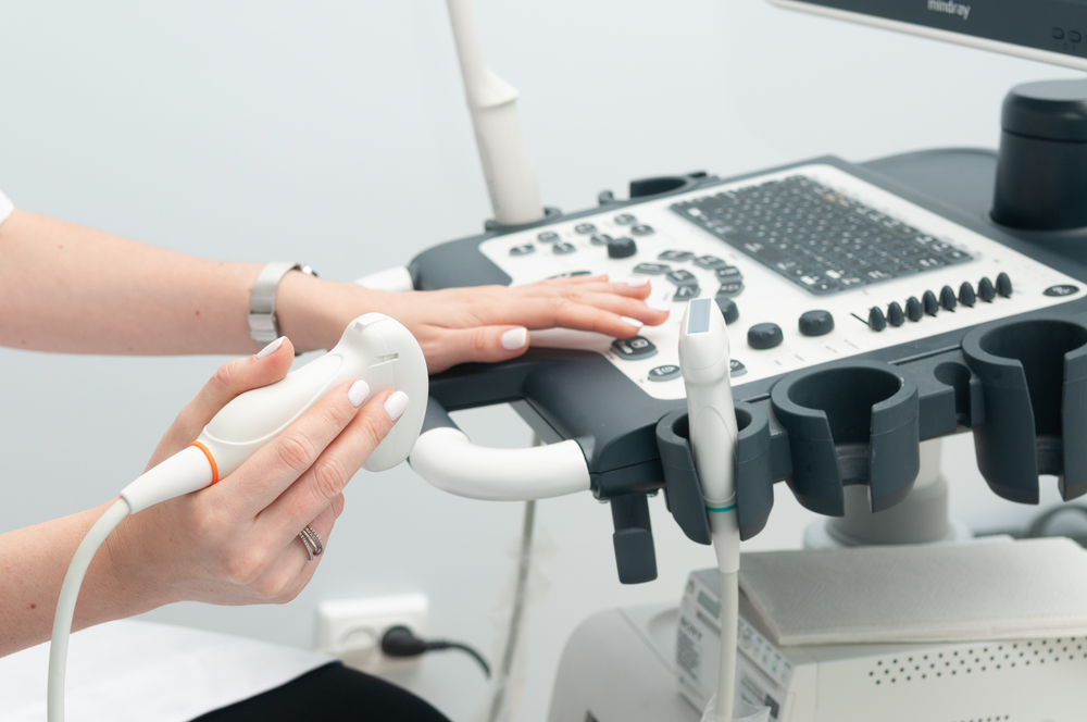 A hand operating ultrasound machine