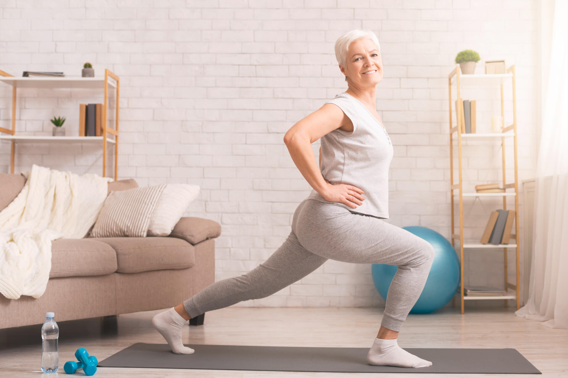 Senior woman exercising legs at home