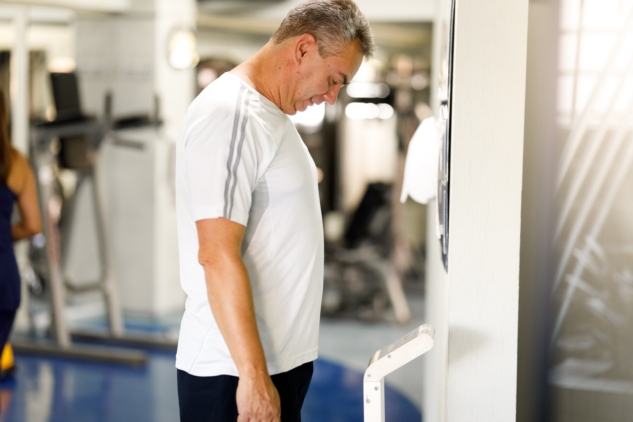 Man weighing himself on the scale