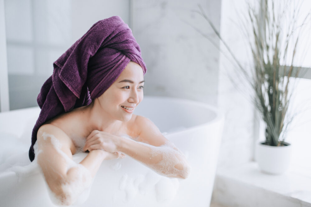 woman taking a bath and feeling happy she cured spider veins