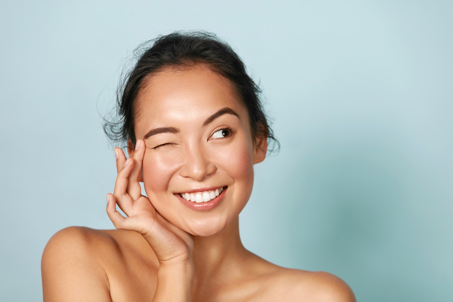 Woman with beauty face touching facial skin